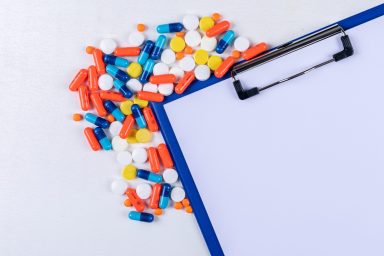 Set of paper holder and pills on a white background. flat lay.