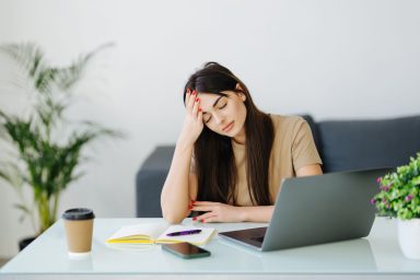 Stressed frustrated woman student looking at laptop reading bad email internet news feeling sad tired of study work online, upset about problem, failed exam test results, difficult learning